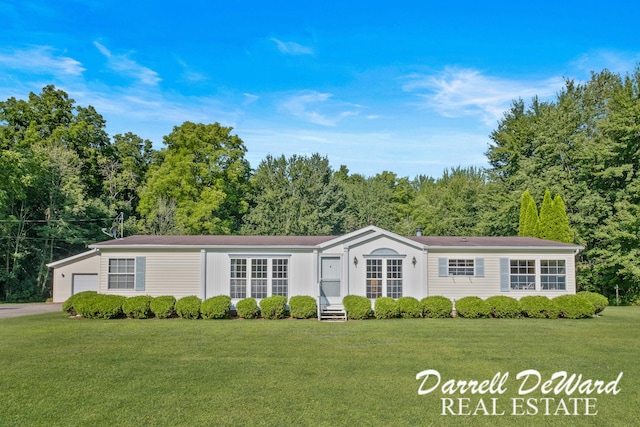 view of front of house with a garage and a front yard