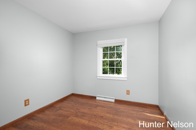 unfurnished room featuring dark wood-type flooring