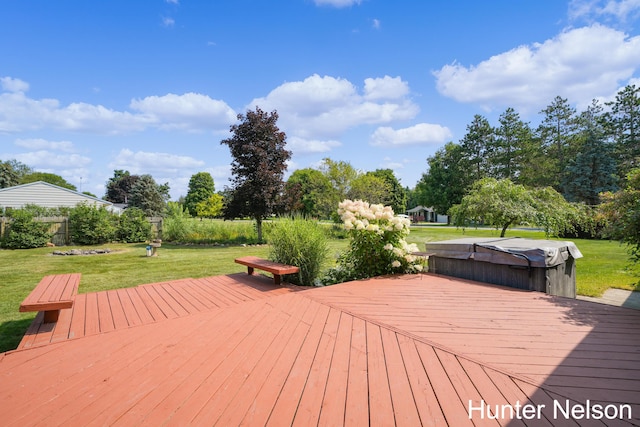 deck featuring a yard and a covered hot tub