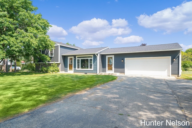 view of front of house with a garage and a front lawn