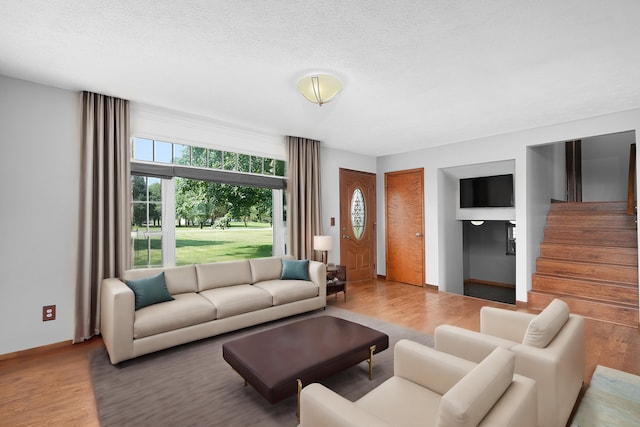 living room featuring hardwood / wood-style floors and a textured ceiling