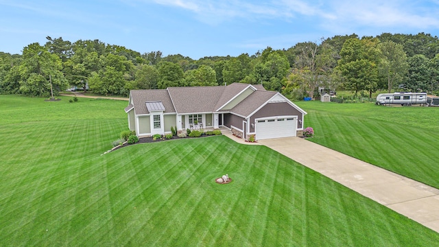 single story home featuring a garage and a front lawn