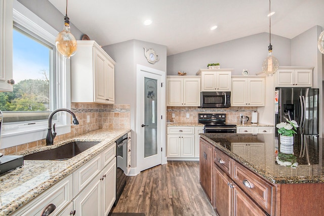 kitchen with range, sink, dark hardwood / wood-style floors, lofted ceiling, and refrigerator