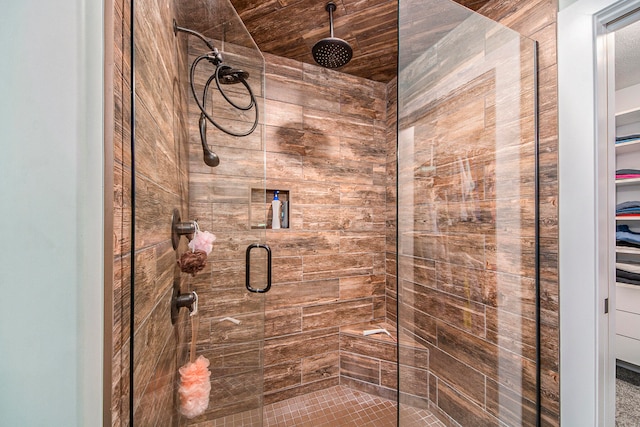 bathroom featuring a shower with door