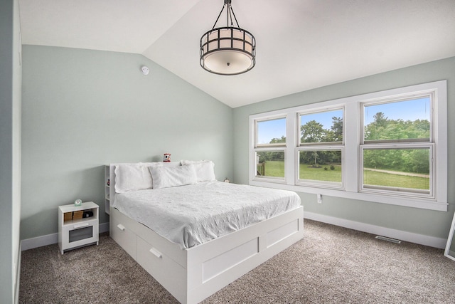 bedroom with baseboards, lofted ceiling, visible vents, and carpet flooring