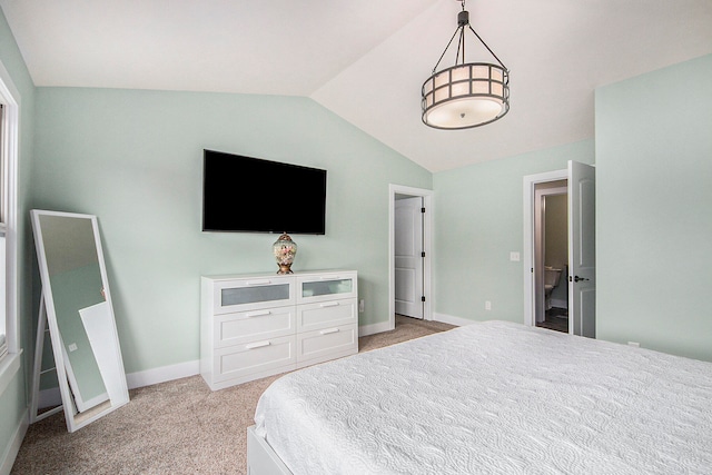 carpeted bedroom with lofted ceiling