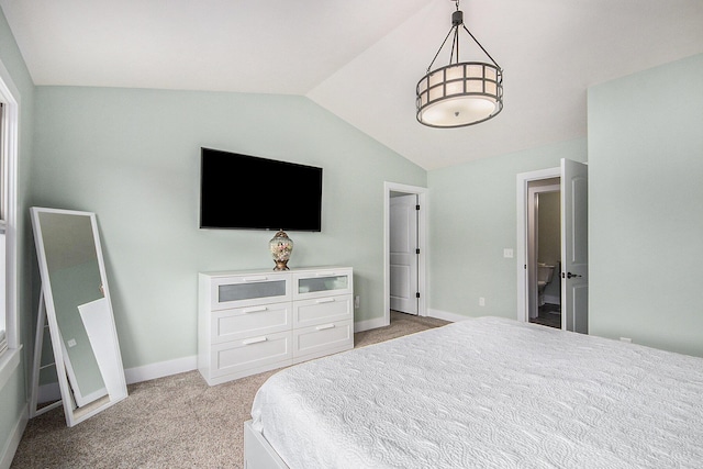 bedroom with baseboards, light carpet, and vaulted ceiling