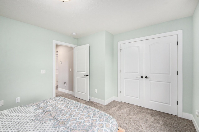 unfurnished bedroom featuring baseboards, a closet, and carpet floors