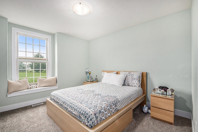 bedroom with carpet flooring, visible vents, and baseboards