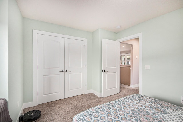 carpeted bedroom with a closet