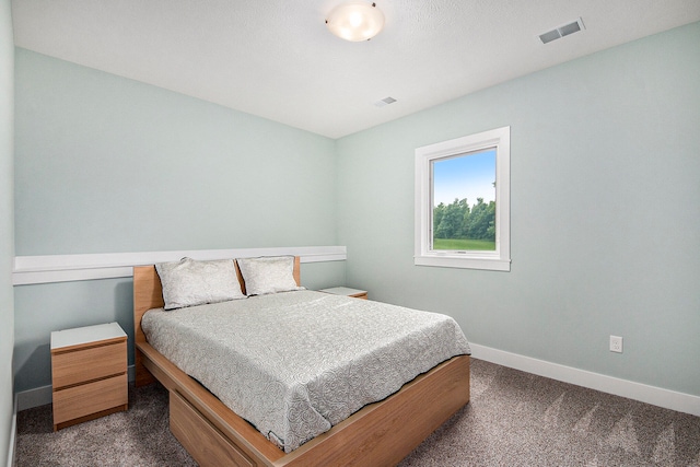 bedroom with dark carpet