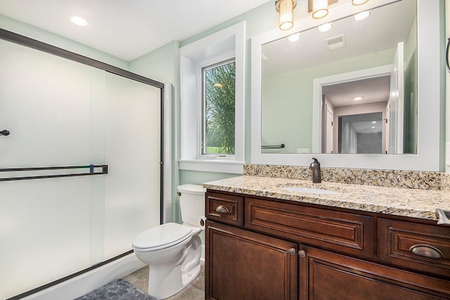 bathroom with vanity, toilet, tile patterned floors, and an enclosed shower