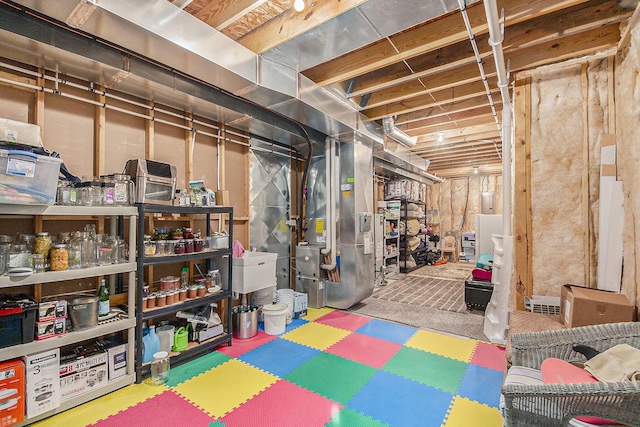 unfinished basement featuring heating unit