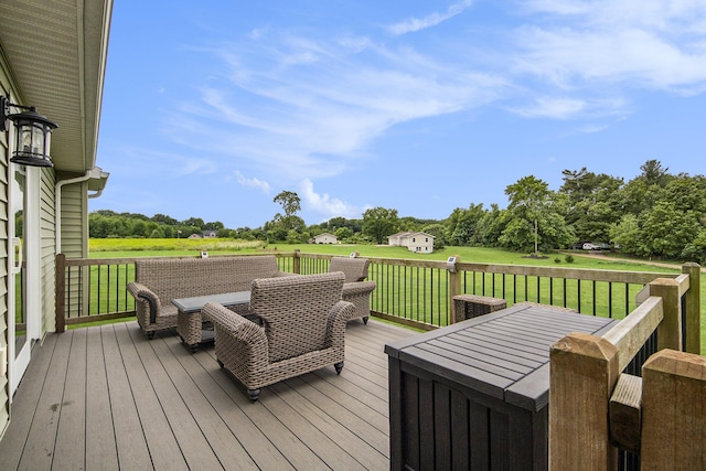 wooden terrace featuring outdoor dining space and a yard