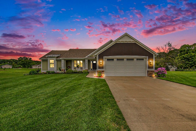 craftsman inspired home featuring a garage and a lawn