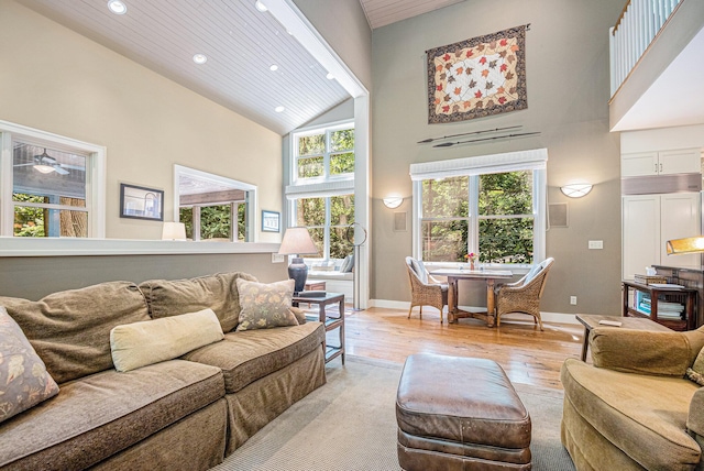 living room with wood ceiling, high vaulted ceiling, and light wood-type flooring