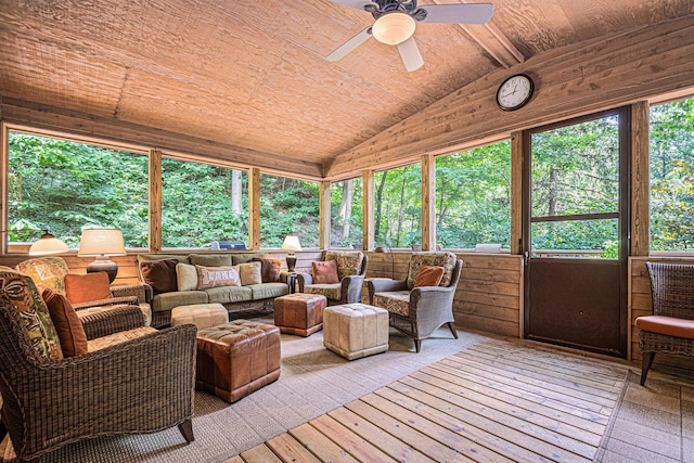 sunroom / solarium with lofted ceiling, wooden ceiling, and ceiling fan