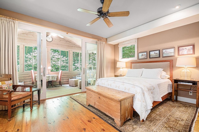 bedroom with ceiling fan, wood-type flooring, and access to exterior