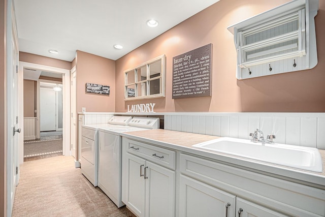 bathroom with sink and washing machine and clothes dryer