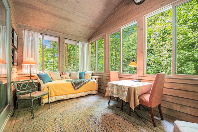 sunroom / solarium with plenty of natural light, vaulted ceiling, and wooden ceiling