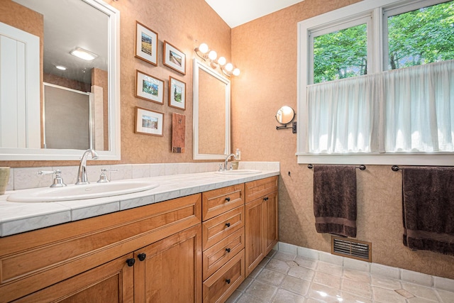 bathroom featuring vanity, an enclosed shower, and tile patterned flooring