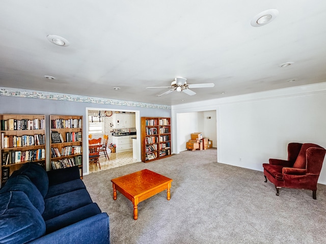 carpeted living room featuring ceiling fan