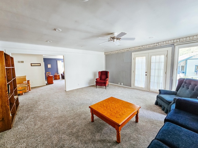 living room featuring french doors, ceiling fan, and carpet flooring