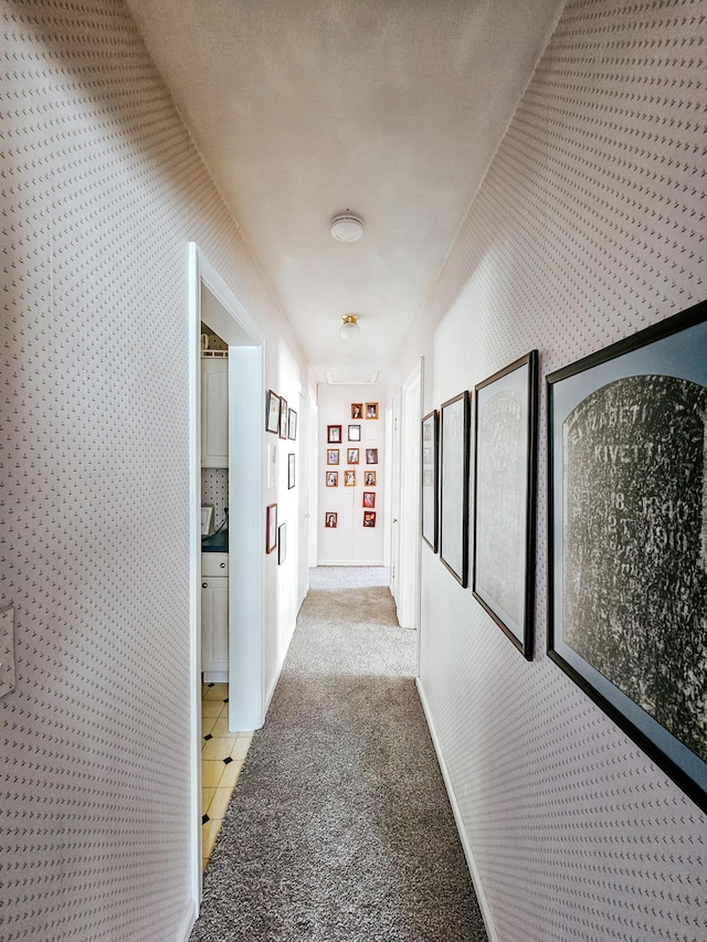 corridor with built in shelves and light colored carpet