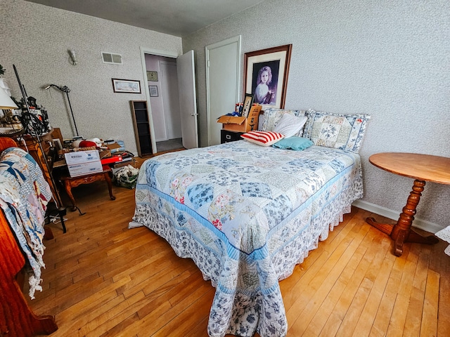 bedroom with hardwood / wood-style flooring