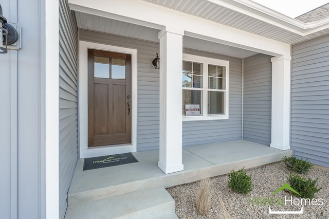 view of exterior entry featuring a porch