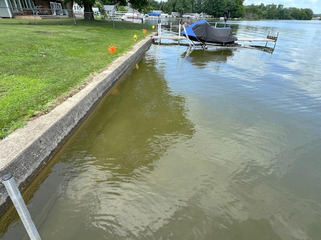 dock area featuring a yard and a water view