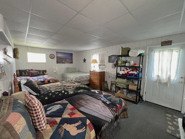 bedroom featuring multiple windows, carpet floors, and a paneled ceiling