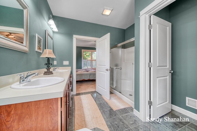 bathroom with vanity and a shower with shower door