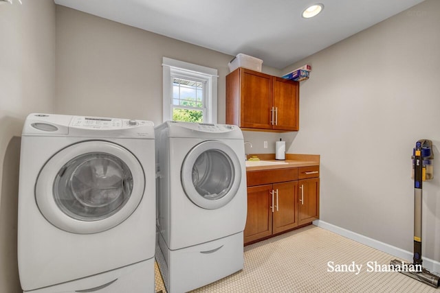 laundry area with cabinets, washing machine and dryer, sink, and light tile patterned floors