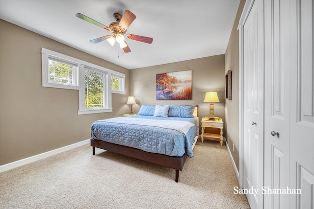 carpeted bedroom with ceiling fan and a closet