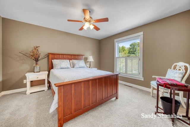 bedroom featuring light colored carpet and ceiling fan