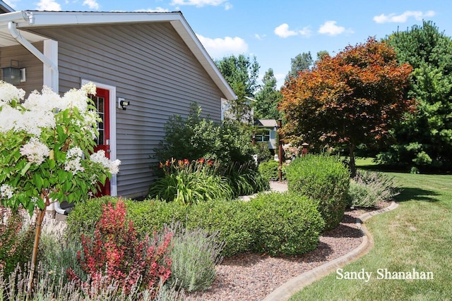 view of home's exterior with a yard