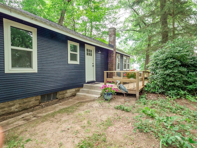 rear view of house featuring a wooden deck