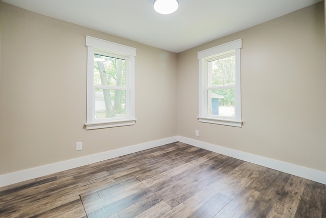 unfurnished room with hardwood / wood-style flooring