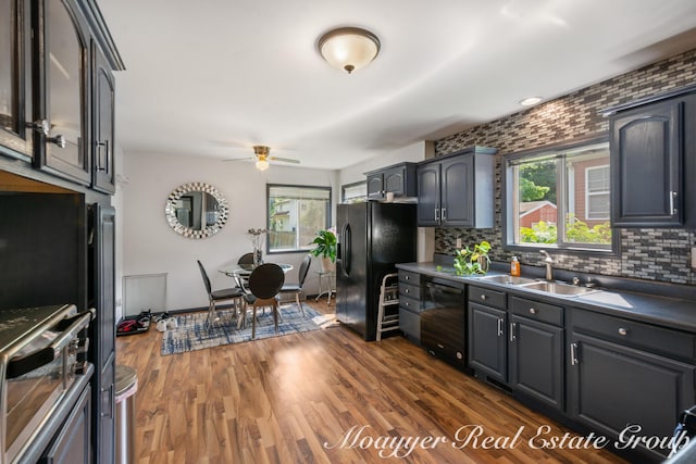 kitchen with sink, dark wood-type flooring, ceiling fan, tasteful backsplash, and black appliances