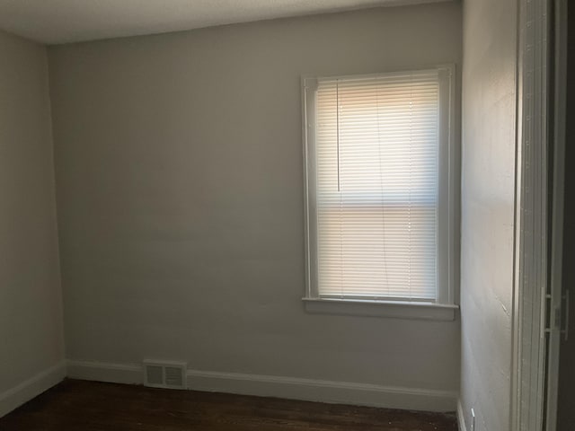 unfurnished room featuring dark hardwood / wood-style flooring