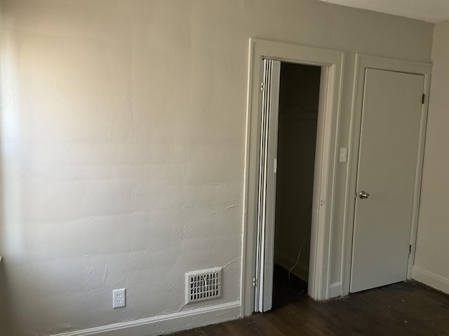 corridor featuring dark hardwood / wood-style floors