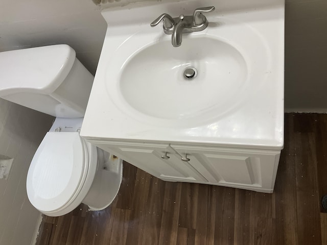 bathroom with sink, wood-type flooring, and toilet