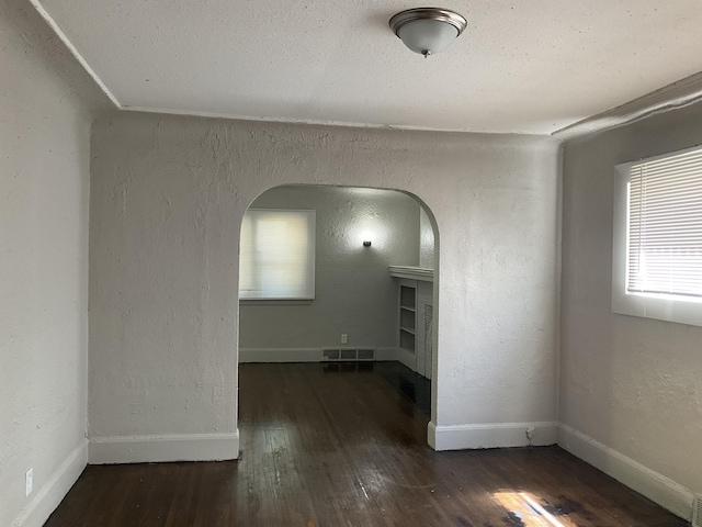 empty room with dark hardwood / wood-style floors