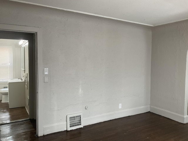 unfurnished room featuring dark hardwood / wood-style floors