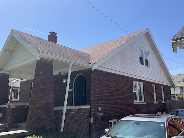 view of side of home featuring a porch