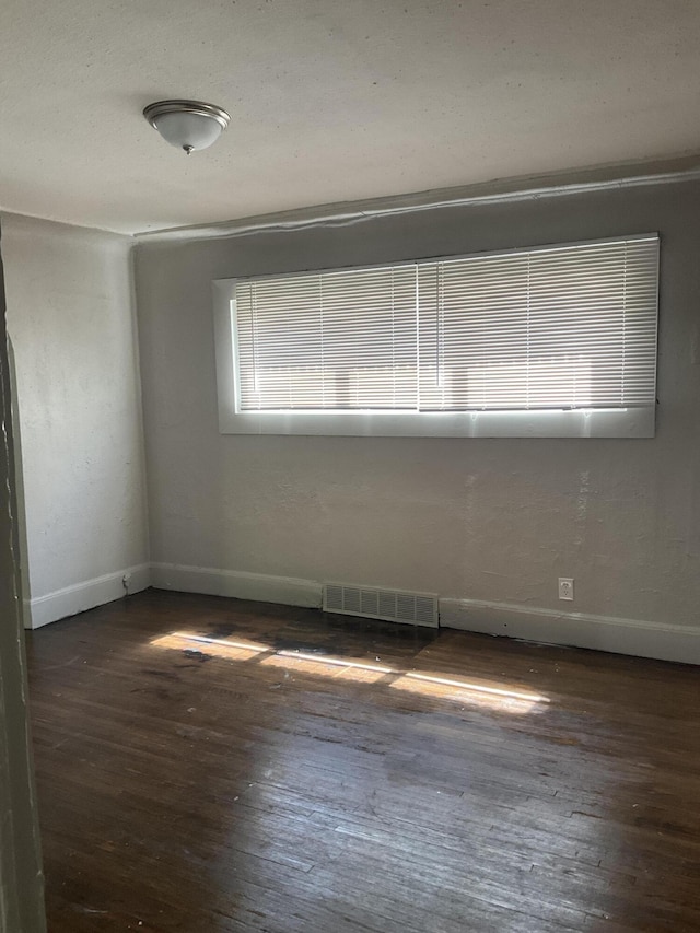 empty room featuring dark hardwood / wood-style flooring