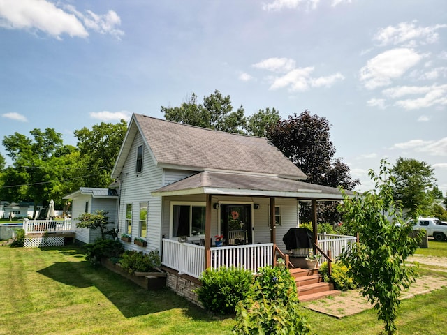 country-style home with a front yard and a porch