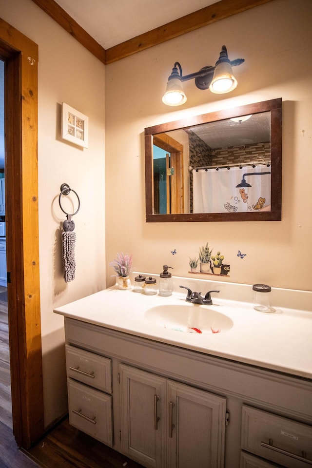 bathroom with ornamental molding, vanity, curtained shower, and hardwood / wood-style floors