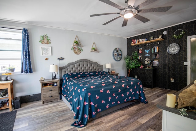 bedroom with ceiling fan and hardwood / wood-style floors